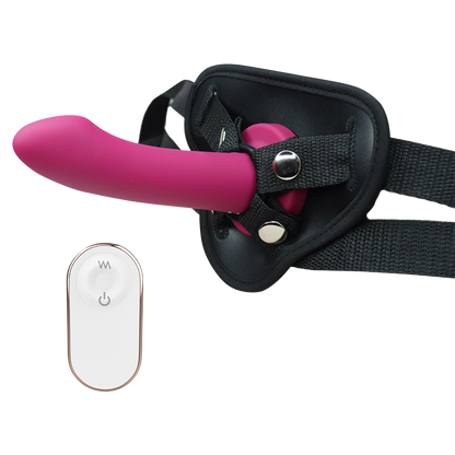 Pink silicone dildo with black harness and remote control on a white background