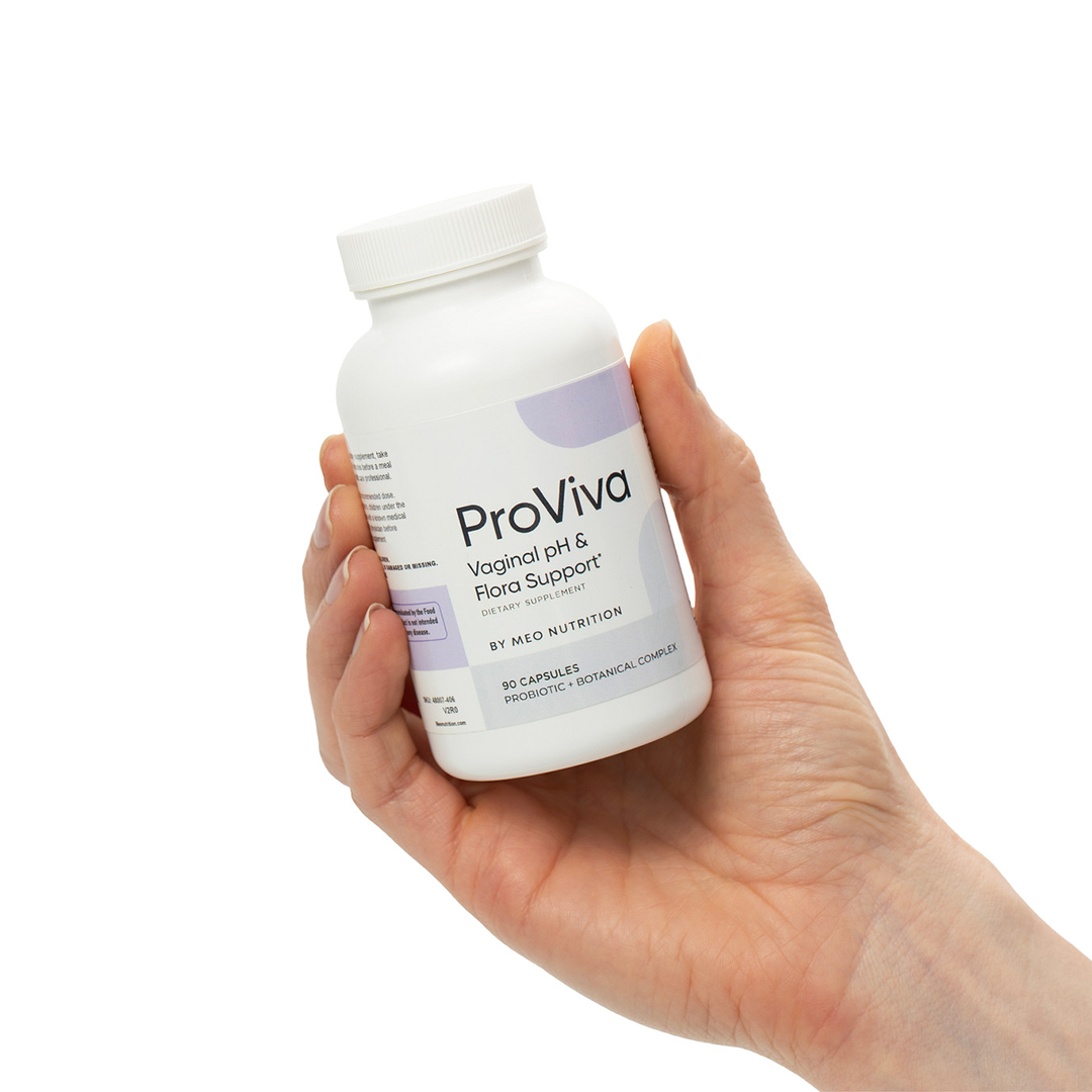 Hand holding a ProViva supplement bottle